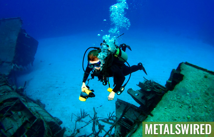 Diver takes photograph at shipwreck site