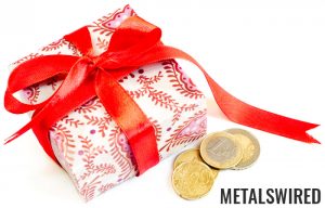 a few collectible coins next to wrapped gift